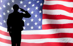 military solider in profile saluting the U.S. flag military solider in profile saluting the U.S. flag