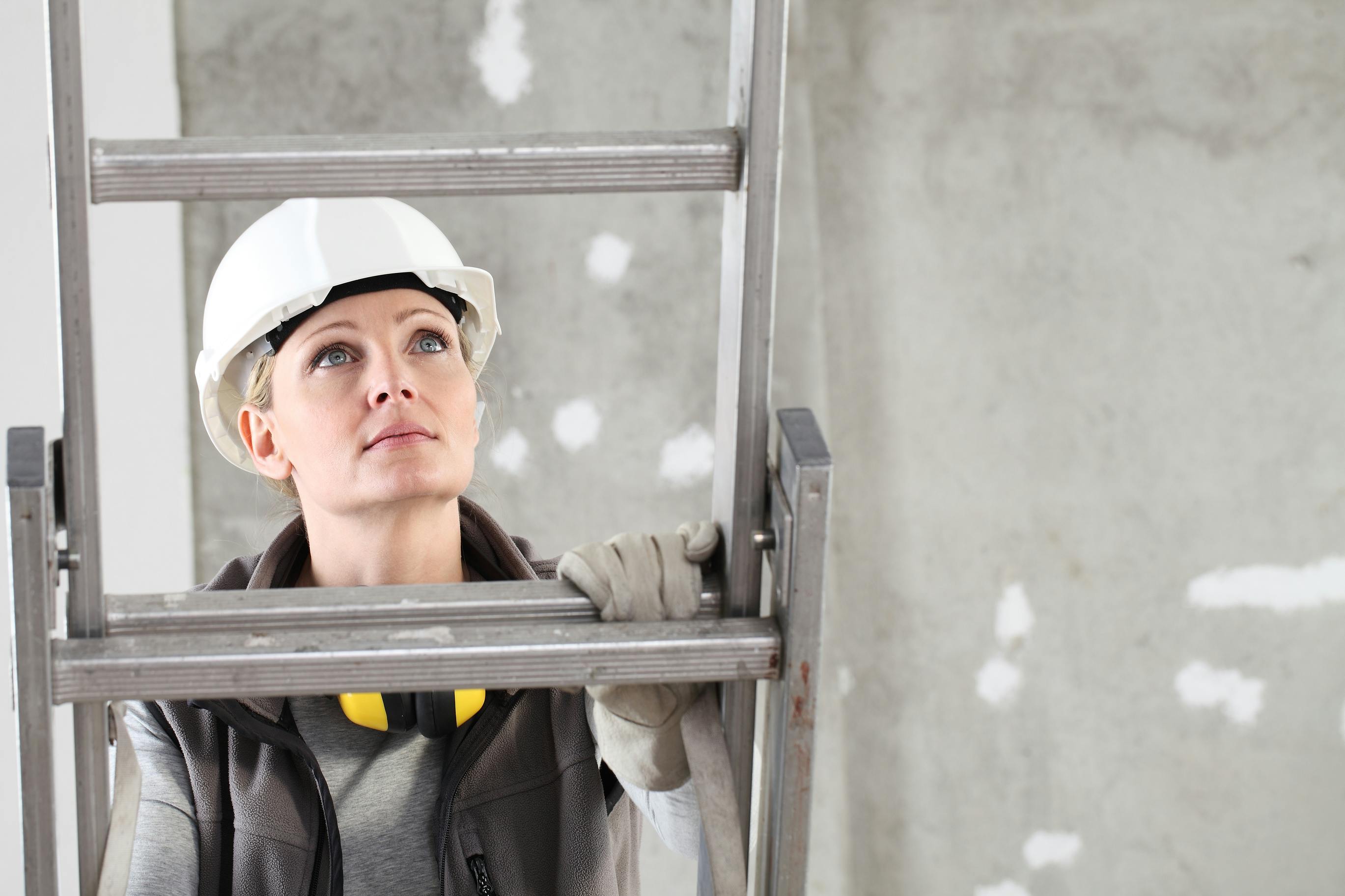 woman climbing on ladder looking upward