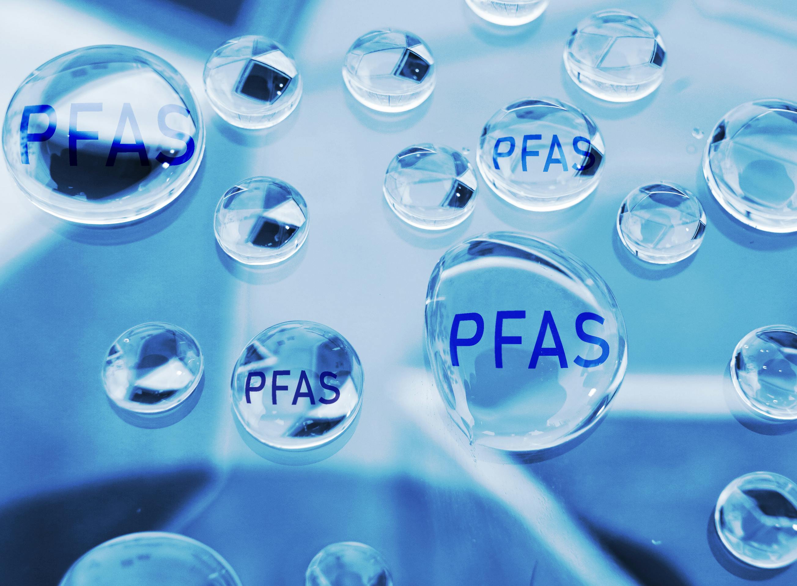 illustration of water droplets with 'PFAS' inside of them.
