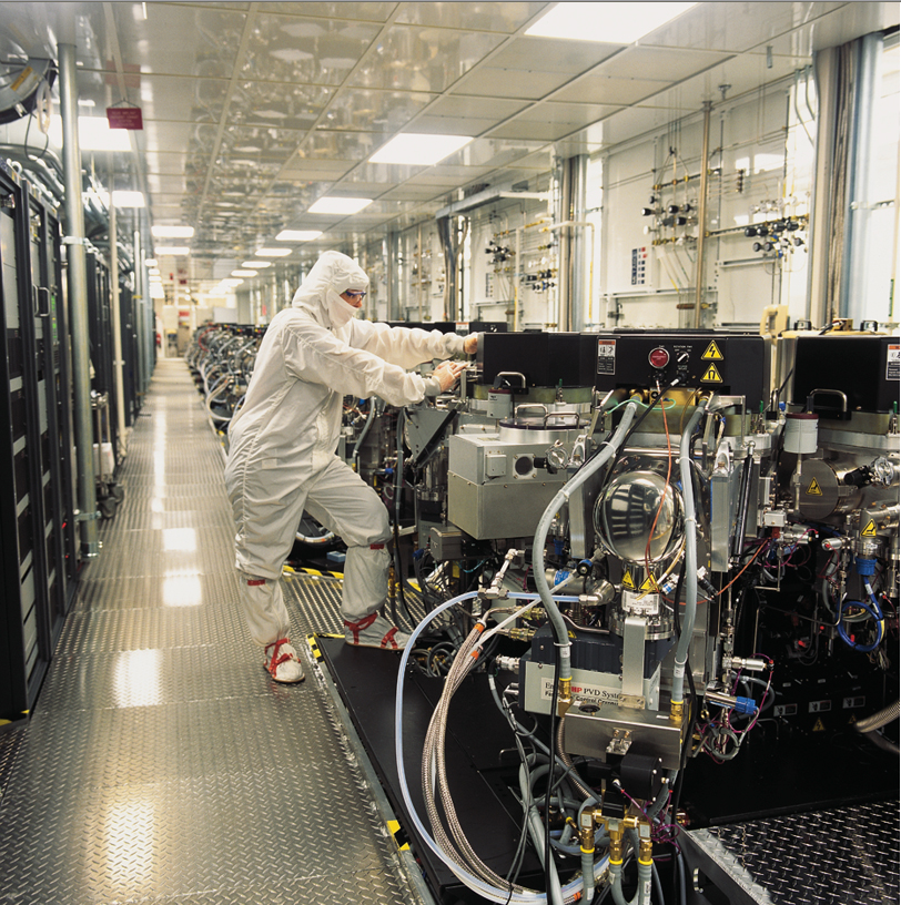 A Micron Technology worker checks semiconductor equipment in a maintenance corridor Image courtesy of Micron Technology