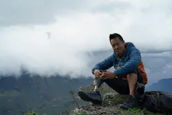 Albert Lin sitting on the edge of a cliff during his quest to find the lost city of the Chachapoyas in Peru. Albert Lin sitting on the edge of a cliff during his quest to find the lost city of the Chachapoyas in Peru.