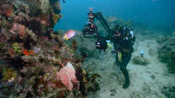 Cinematographer, Rory McGuinnes, operates an underwater jib arm to film a colorful coral reef on the Lembeh Strait. (National Geographic for Disney/Adam Geiger) Cinematographer, Rory McGuinnes, operates an underwater jib arm to film a colorful coral reef on the Lembeh Strait. (National Geographic for Disney/Adam Geiger)