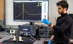 2. The unit under test at the team site at the University of British Columbia/Okangan is placed between two waveguide-compatible test-lead interface connectors. Team member Omid Niksan holds a prototype of a 3D-printed MXene-coated component. 2. The unit under test at the team site at the University of British Columbia/Okangan is placed between two waveguide-compatible test-lead interface connectors. Team member Omid Niksan holds a prototype of a 3D-printed MXene-coated component.