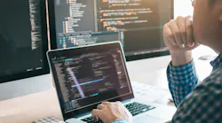 Programmer looking at software Programmer looking at software