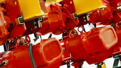 Red wire rope hoist machinery ready for lifting operations in a modern industrial facility Red wire rope hoist machinery ready for lifting operations in a modern industrial facility