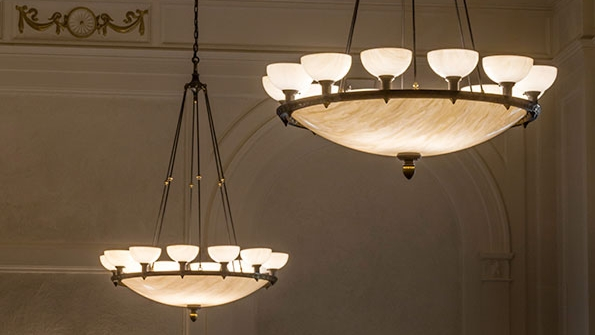 Restored lighting fixtures in Whitesbororsquos Middle School Auditorium after Meyda converted them to efficient LED lamping for energy and maintenance cost savings