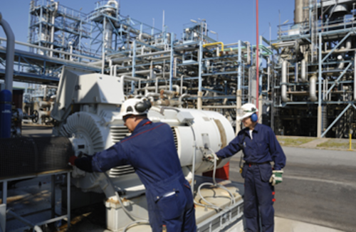 Technicians Inspecting Pumps