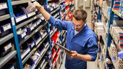 Counterman or warehouse worker pulling parts from shelf Counterman or warehouse worker pulling parts from shelf