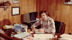 Bob Barks takes care of some paperwork in his office in this early, undated photo. Sharp-eyed readers will notice the microfiche reader behind him and to the right. Bob Barks takes care of some paperwork in his office in this early, undated photo. Sharp-eyed readers will notice the microfiche reader behind him and to the right.
