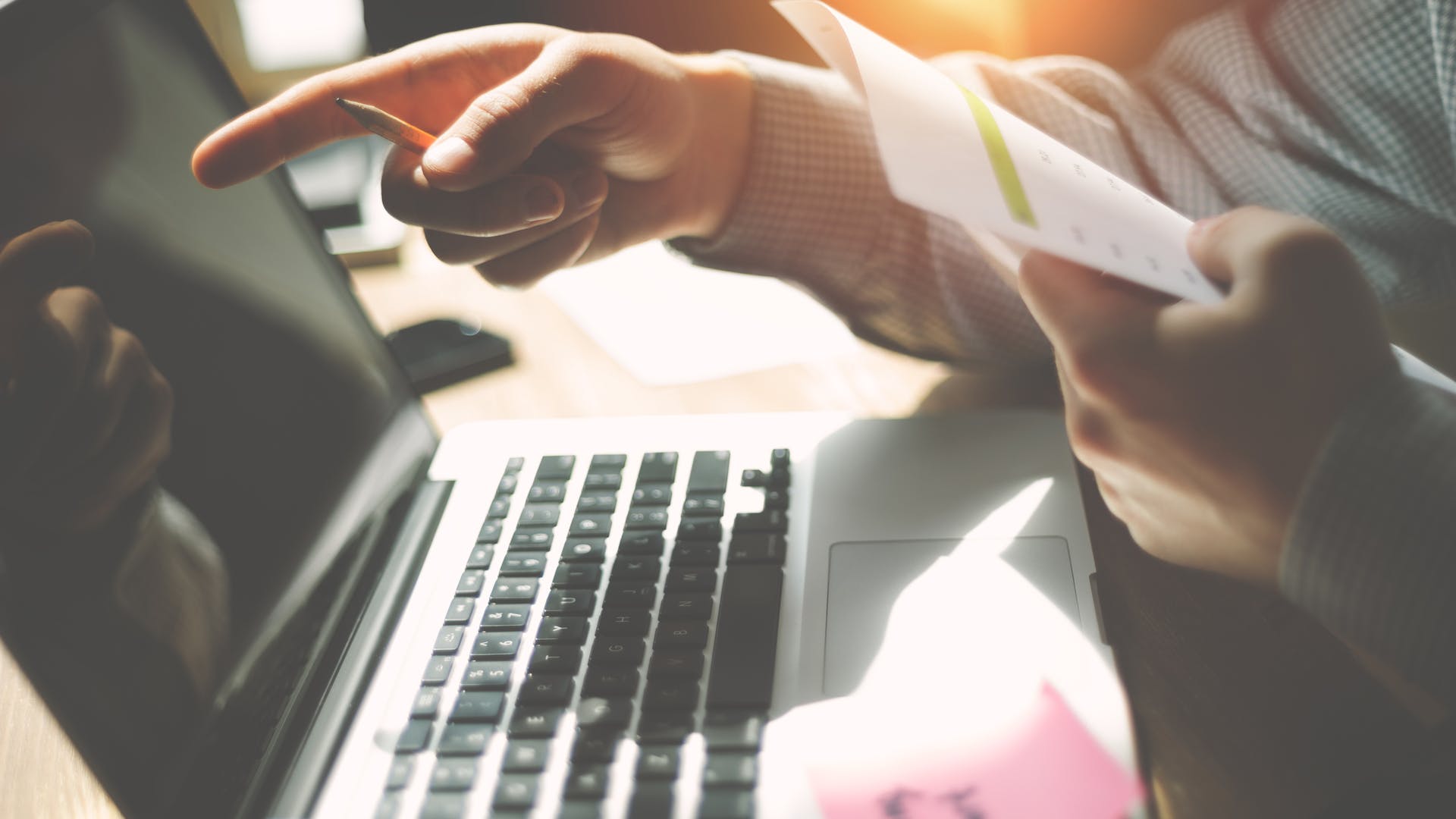 Man With Paper Pointing At Computer Screen Dreamstime M 112964592 (1)