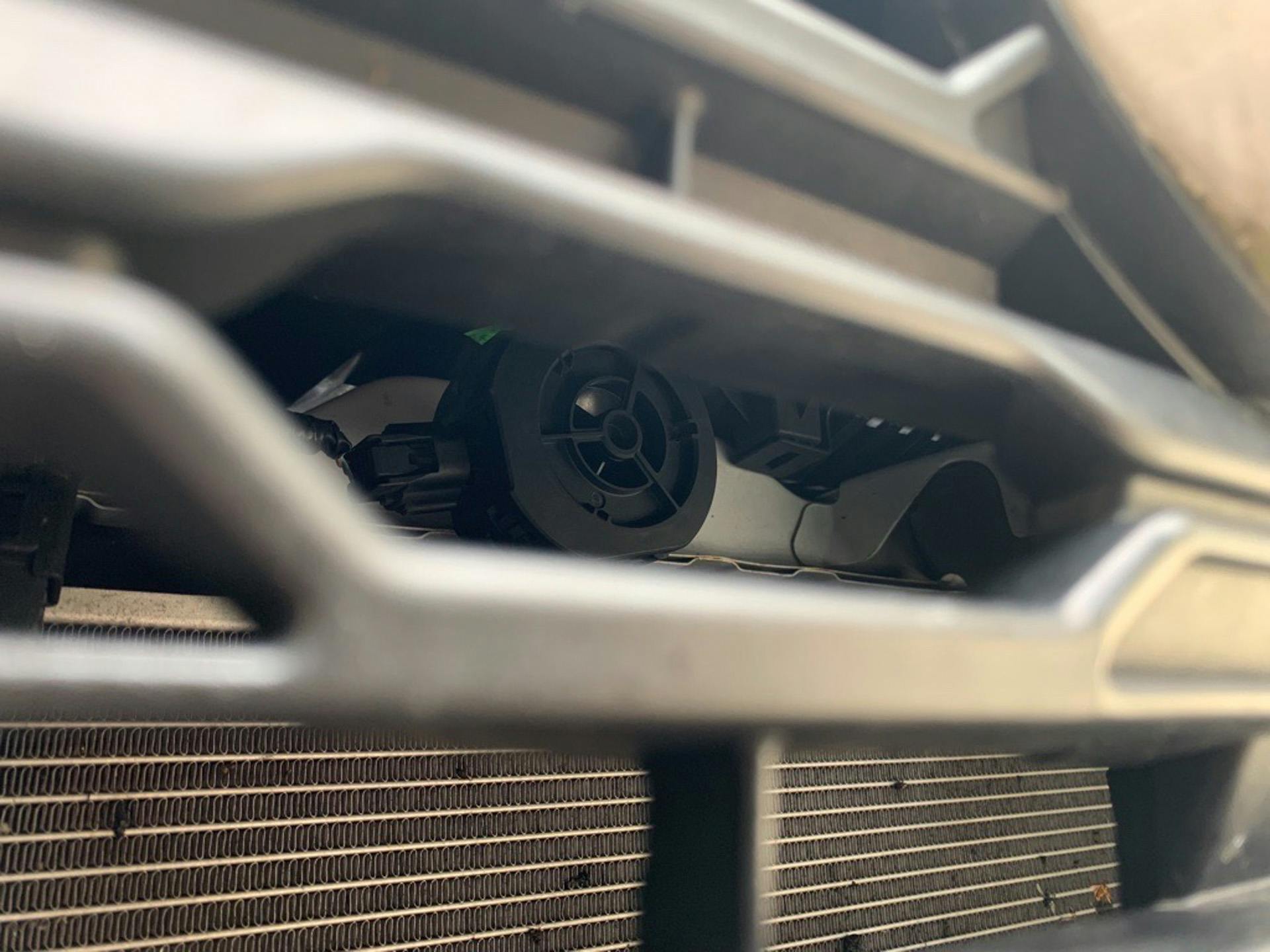 AVAS speaker, as seen through the grille of a Toyota RAV4 Hybrid. On an EV there obviously wouldn&rsquo;t be a grille, so the speakers are often mounted behind body paneling or beneath the vehicle.