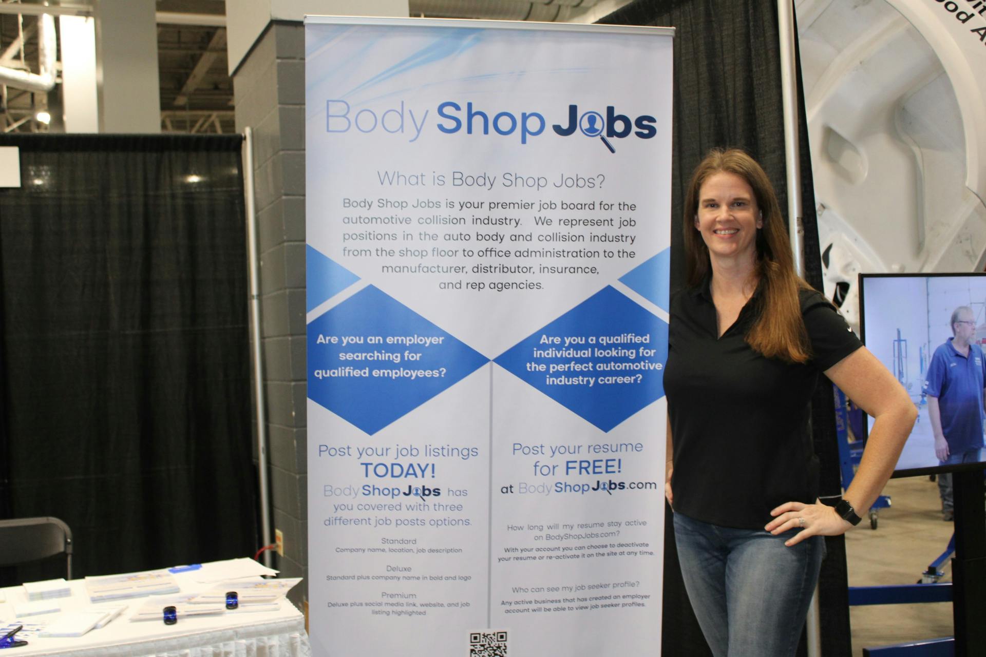 President Diane Benting poses for a photo at the BodyShopJobs.com booth at the Tasco Auto Color trade show.