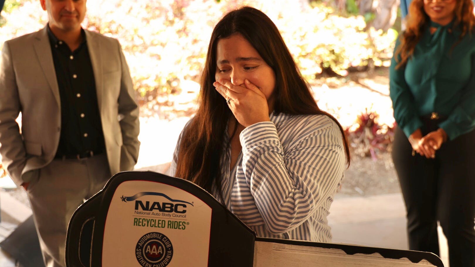 Cindy Cepeda, a military wife with three children, cries after receiving a car from the NABC Recycled Rides program.