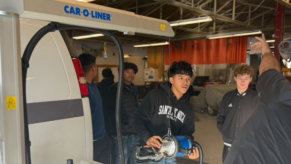Students at Ogden High School gather to interact with the new Car-O-Liner resistance spot welder.