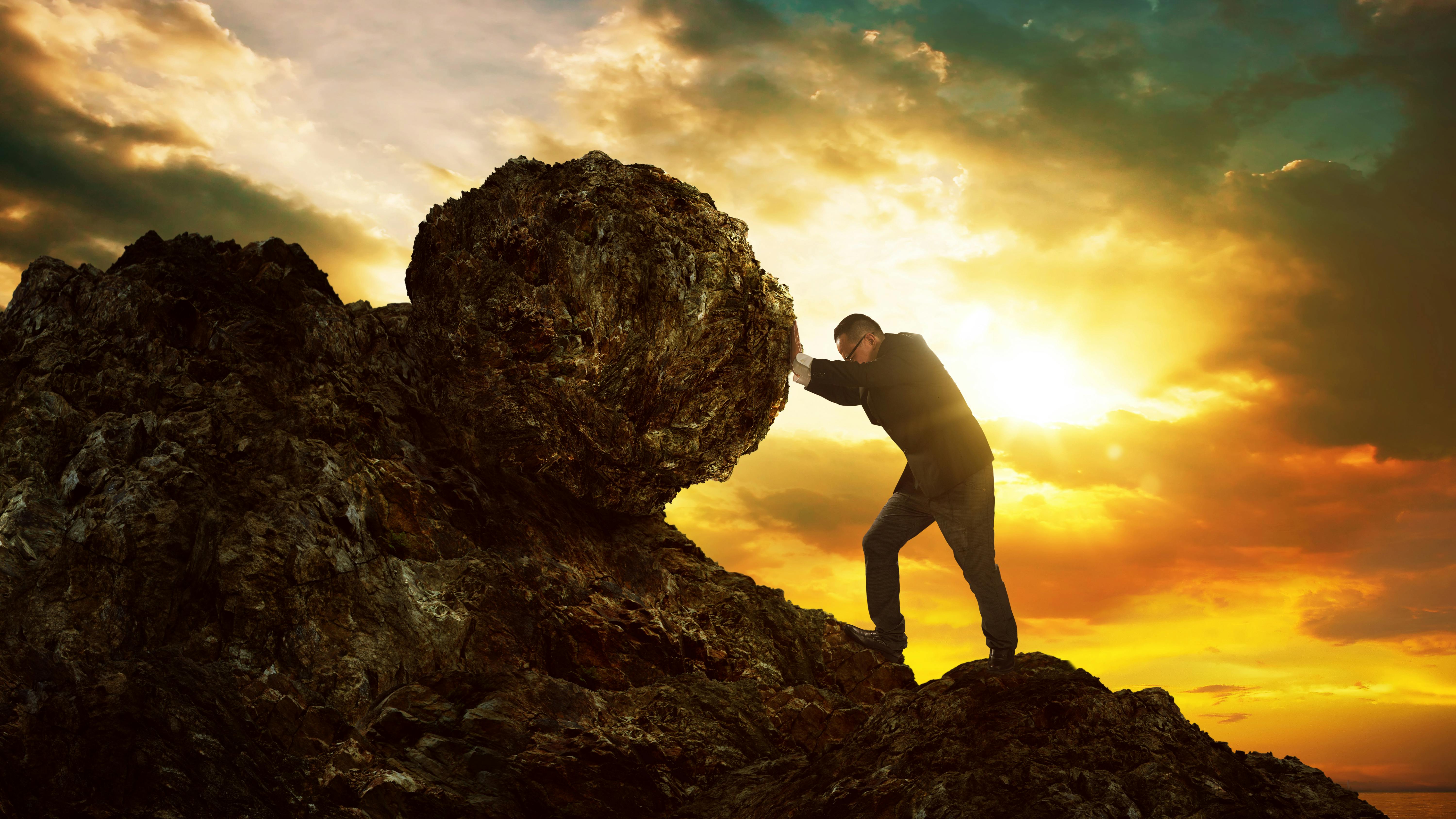 Man pushing a boulder