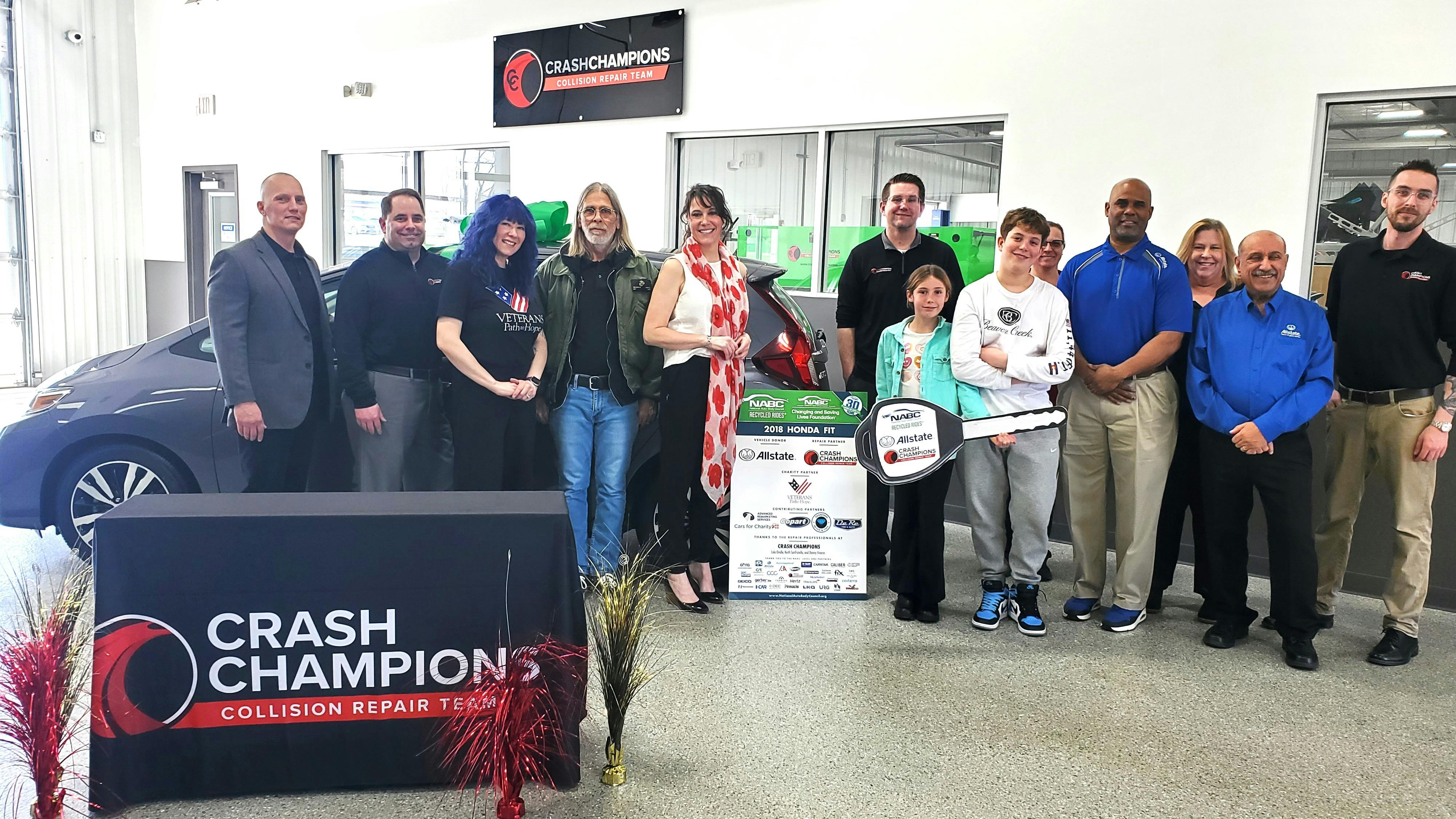 Air Force veteran Kathryn Spangler receives a 2018 Honda Fit from the National Auto Body Council Recycled Rides program, Allstate, and Crash Champions.