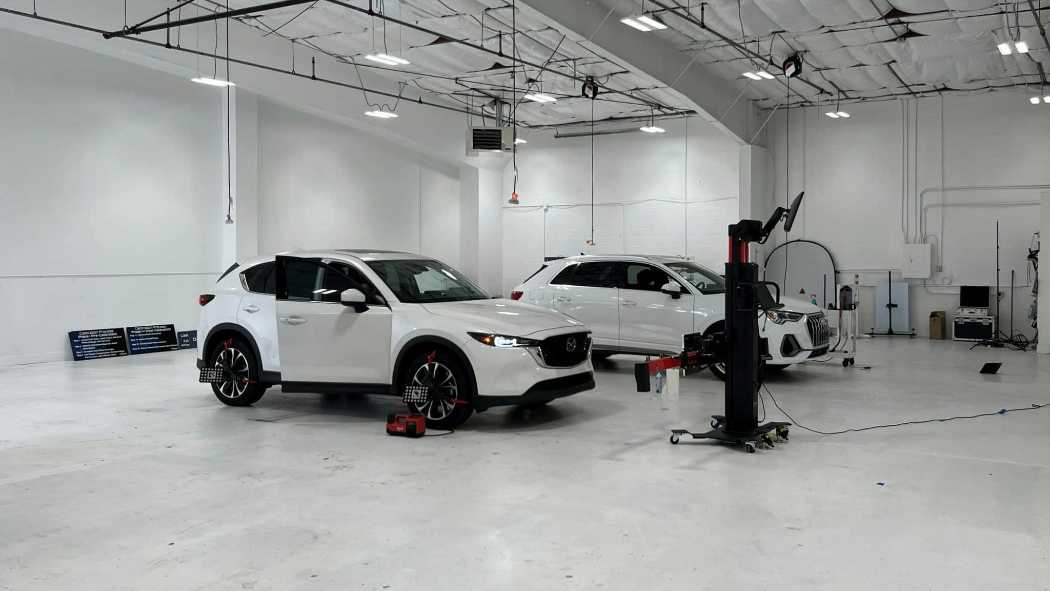 2whitecarsinshop1scaled