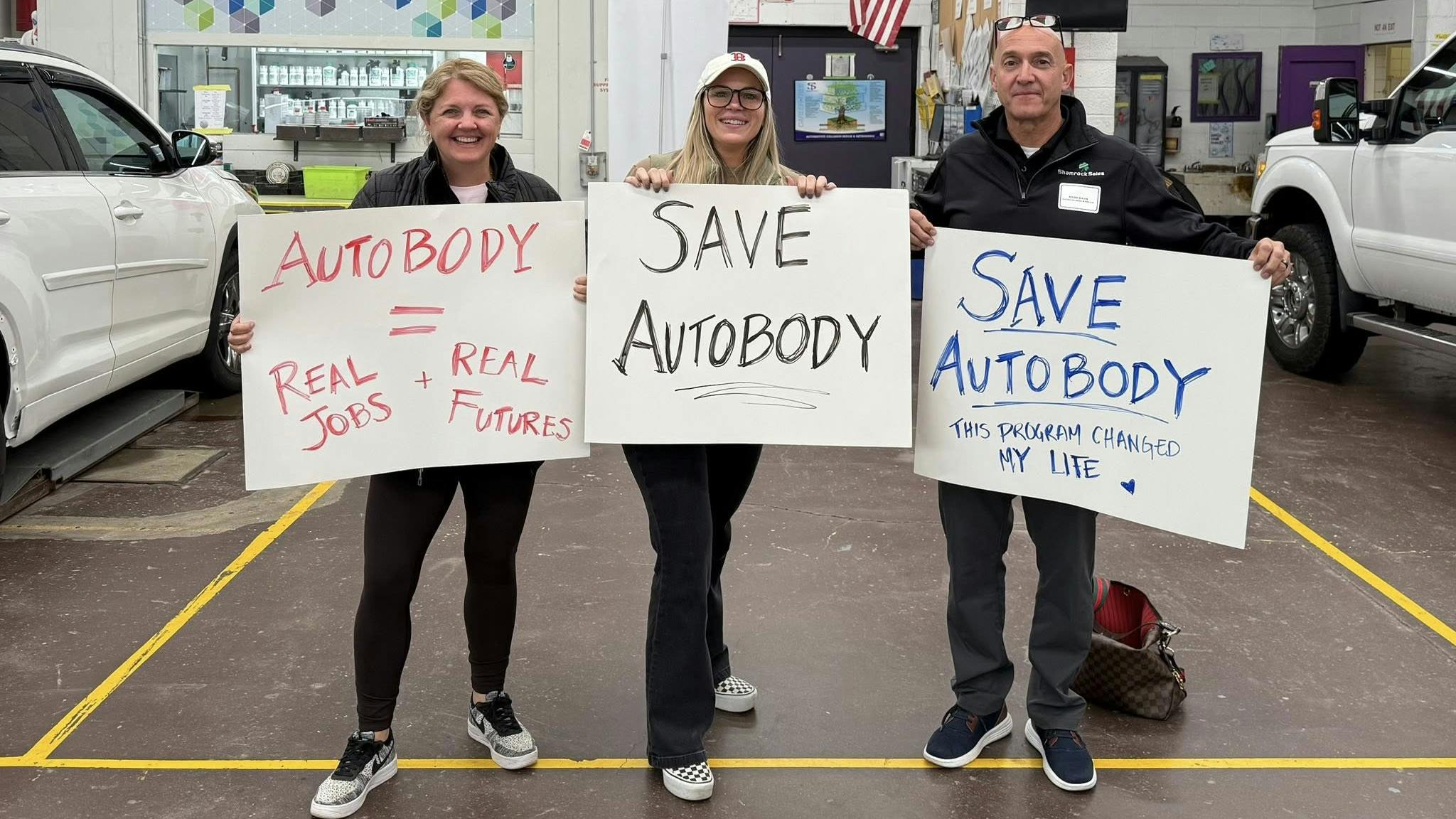 Kelly Lightbown of DB National Warehouse Supply, Rachel James of Torque Financial Group, and Mark Davis of Shamrock Sales show support for the Shawsheen Valley Technical High School Auto Collision Program at a school Advisory Board meeting on October 16.
