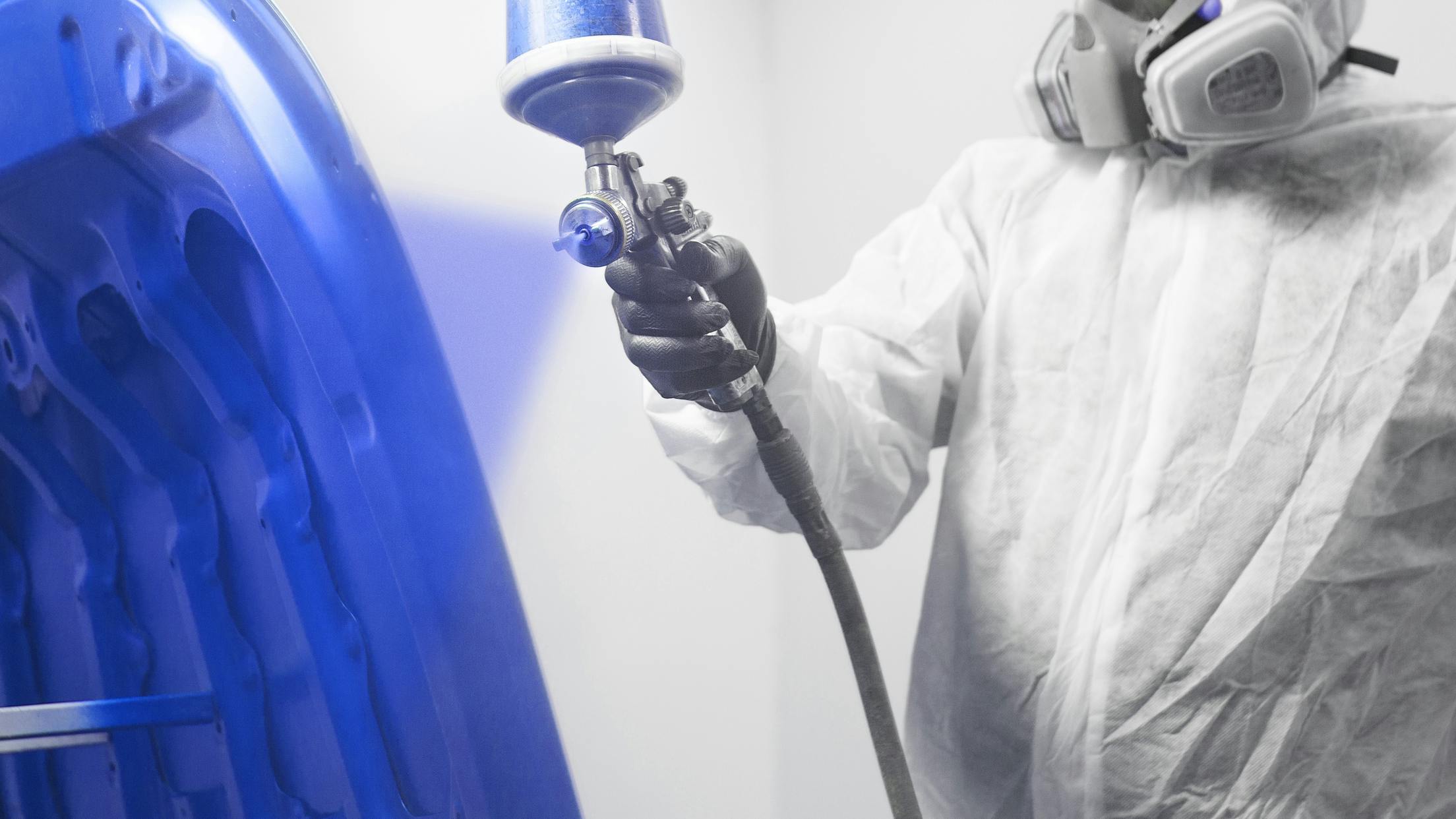 Painter Spraying Blue Hood