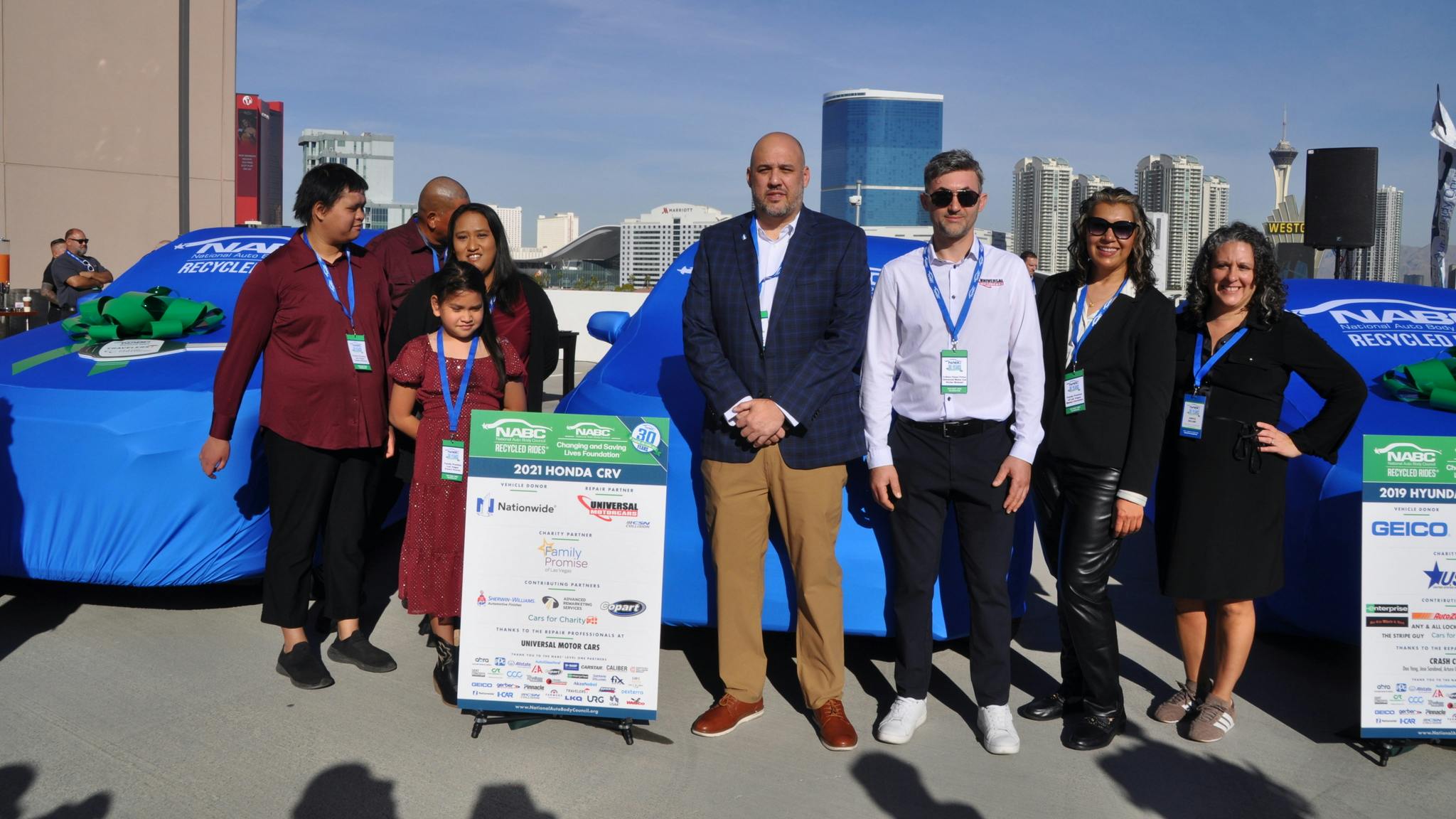 William Hussey receives a refurbished 2021 Honda CRV during a special National Auto Body Council Recycled Rides Program presentation on the rooftop of the Renaissance Hotel parking facility overlooking the Las Vegas Convention Center on Wednesday, Nov. 5.