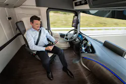 Driver of MercedesBenz Future Truck 2025 attends to other tasks while vehicle in selfdriving mode Driver of MercedesBenz Future Truck 2025 attends to other tasks while vehicle in selfdriving mode