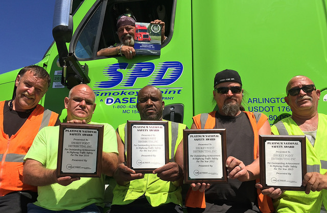 Smokey Point Distributing drivers proudly display the Platinum National Safety Award presented to their company by Great West Casualty Company a leading insurer of trucks and fleets This is the 7th time that Great West has presented Smokey Point Distributing with its highestlevel safety award Inside truck top Dave Miller Outside truck L to R Rick Terletter Doug Larson Kelly Robertson Les Robarge and Jimmy Galvin
