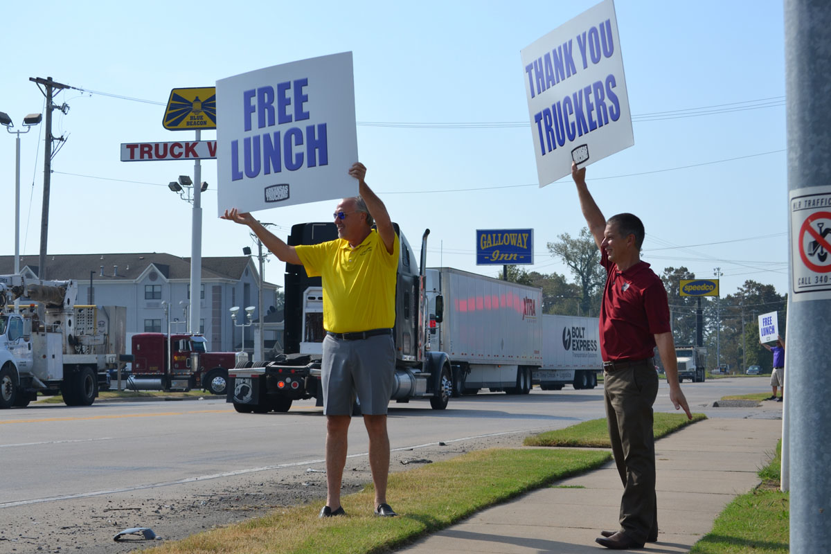 Arkansas Trucking Assn Chairman Butch Rice and Gary Jaworski a member of the Arkansas Road Team direct traffic to Thursday39s Driver Appreciation Day picnic