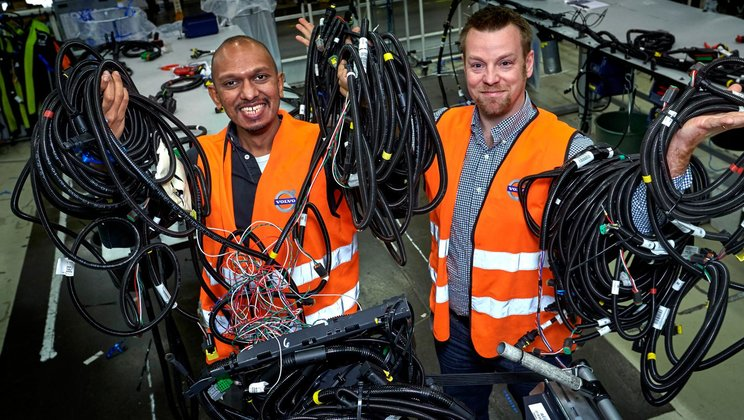 Volvo Truck employees holding cables
