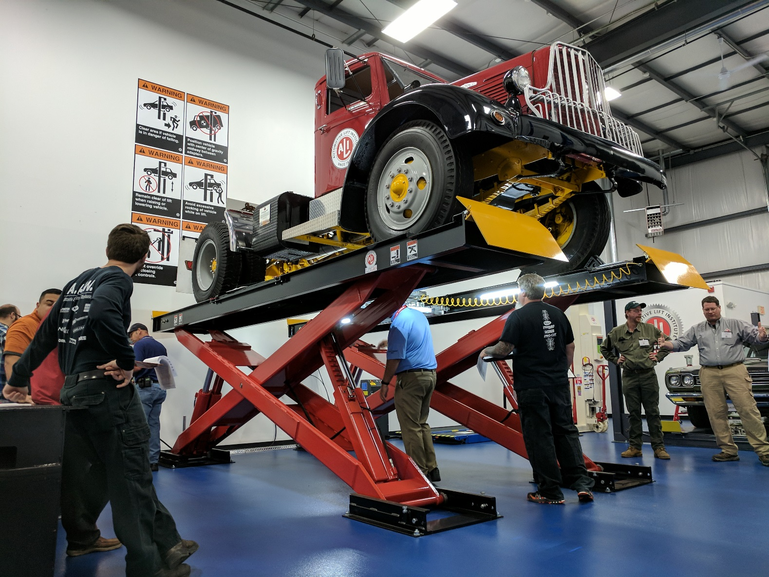 A 1946 Brockway 260XW heavyduty truck is up on a lift that is being inspected by men during an inspector certification class at the new Automotive Lift Institute39s LiftLab in Cortland NY Photo Josh FisherFleet Owner