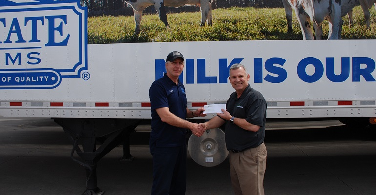 Larry Gardner, at left, receives a Fuel Champ Award from Ed McCarthy, vice president of operations and customer success at Vnomics.