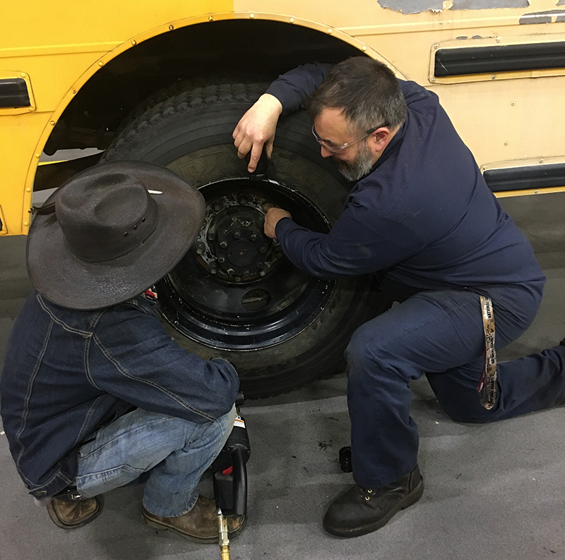 Diesel technology teacher Tyson Sontag instructs a students on the finer points of truck and bus maintenance.