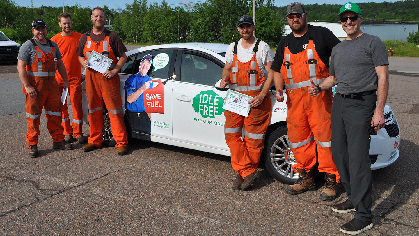 Ron Zima (right), the self-proclaimed 'Idle-Free Guy,' stands with the drivers of a fleet who just finished his idle-reduction certification program, 'Idle-Free for Kids.'