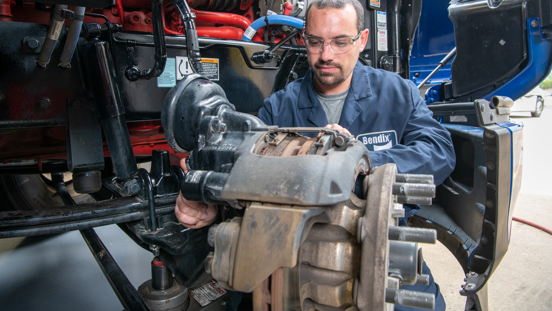 A technician works on air disc brakes.