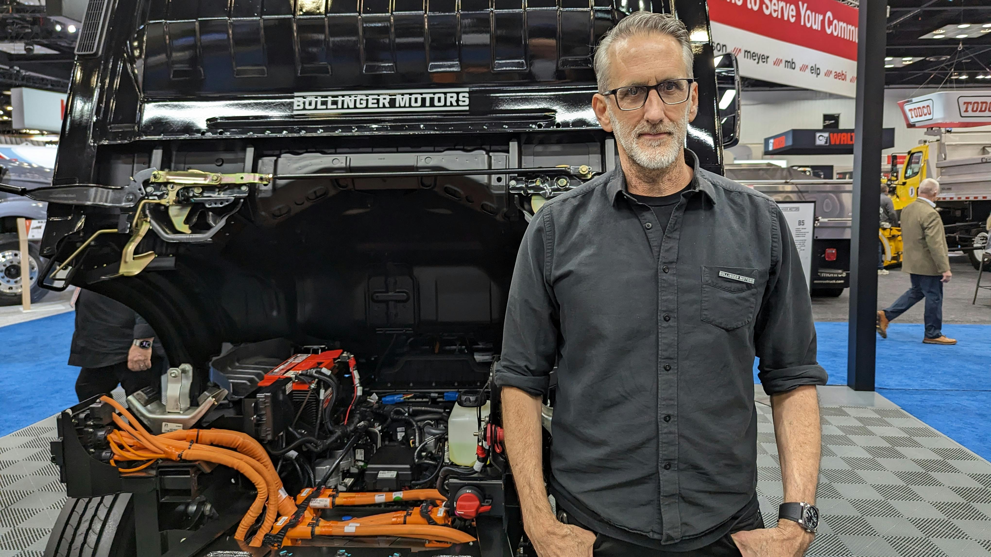 Robert Bollinger, CEO and founder of Bollinger Motors, stands with his B4 chassis cab model, a battery-electric Class 4 work truck. at NTEA's Work Truck Week in Indianapolis.