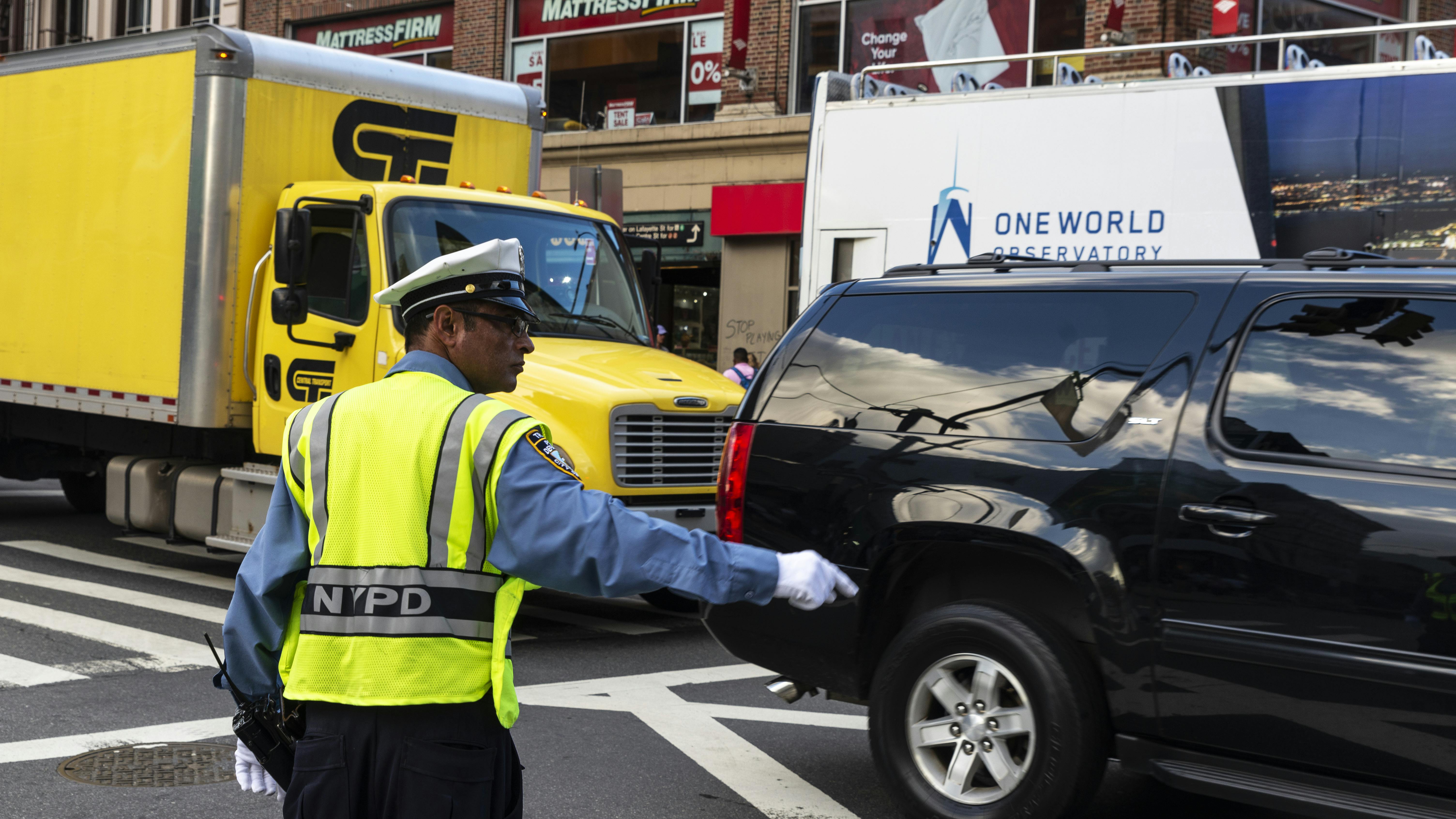 A New York police officer directs traffic in lower Manhattan.