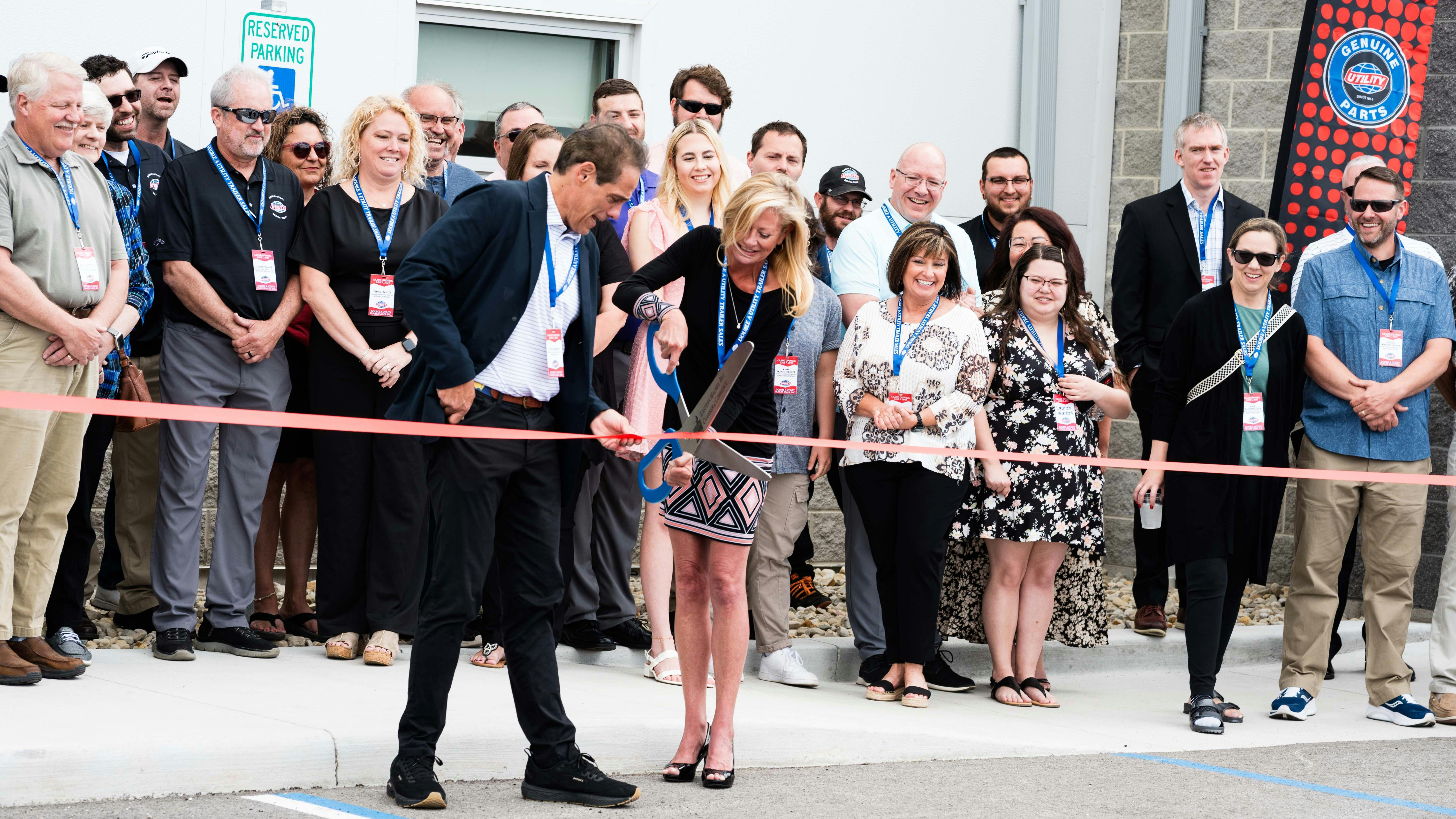 Steve Bennett of Utility Trailer Manufacturing and Leann Wannemacher cut the ribbon on the new Toledo, Ohio, facility.