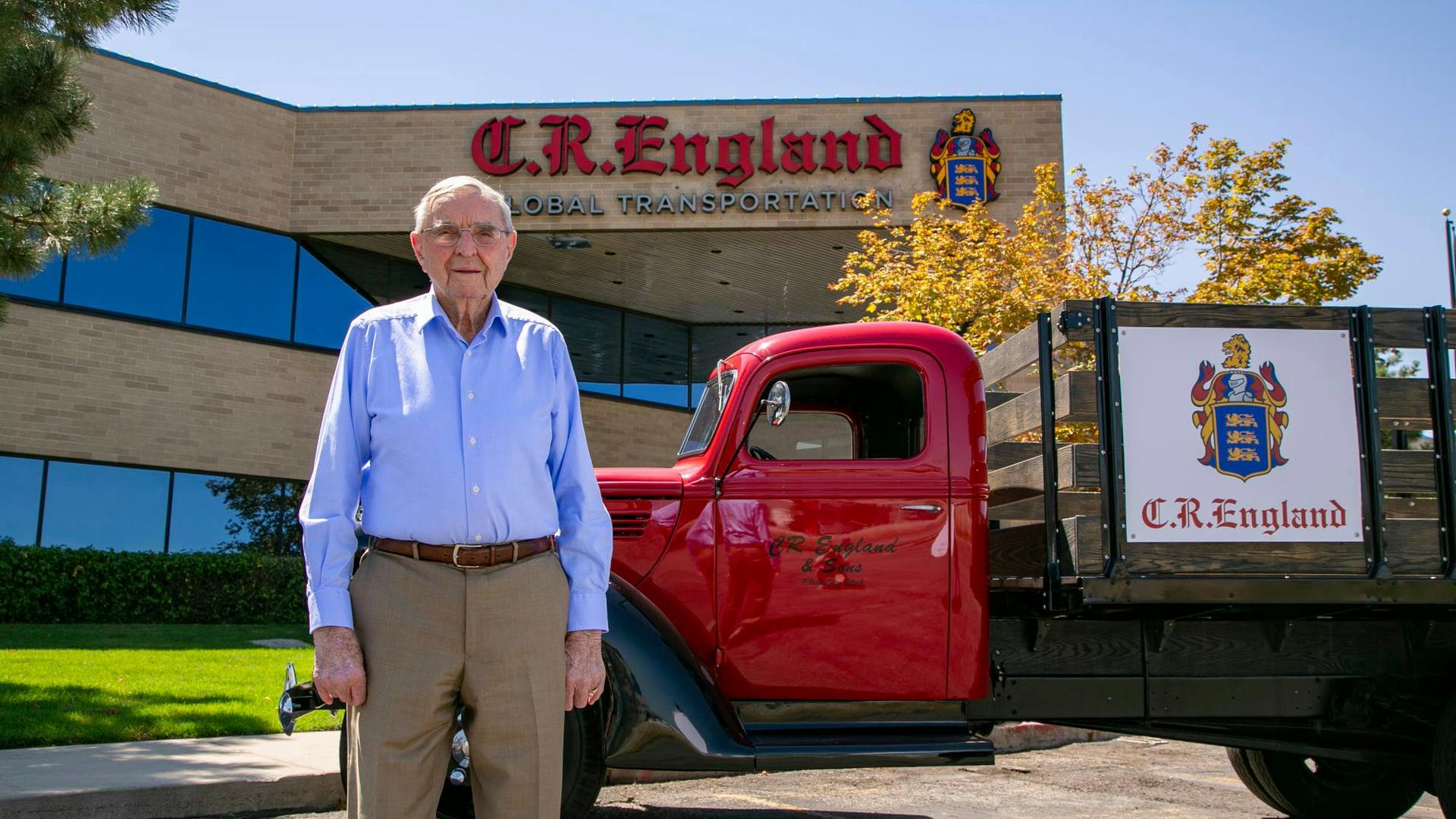 G.E. &ldquo;Gene&rdquo; England stands with a vintage C.R. England truck outside the fleet's Salt Lake City headquarters in 2023.
