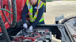 A technician installs the IdleLess hardware on a truck. A technician installs the IdleLess hardware on a truck.