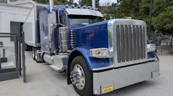 A Peterbilt 389 tractor-trailer with student driver tags unloads at the Greek Theatre in Los Angeles. A Peterbilt 389 tractor-trailer with student driver tags unloads at the Greek Theatre in Los Angeles.