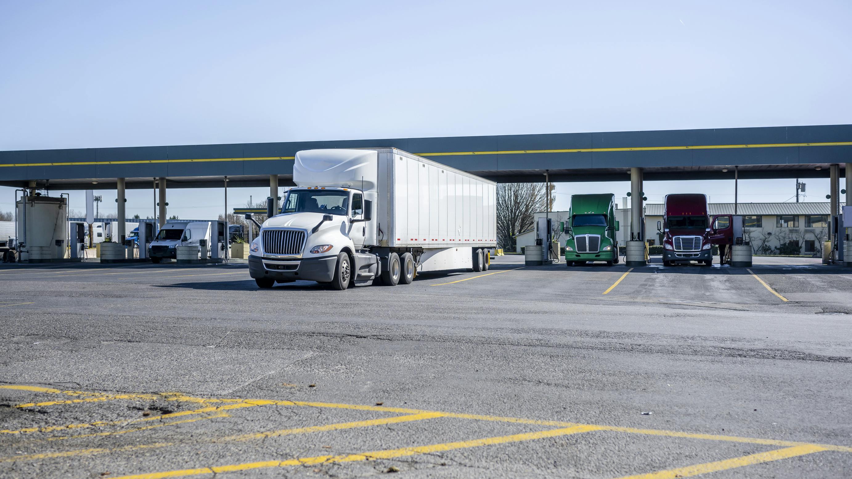 Semi trucks at gas station during the day