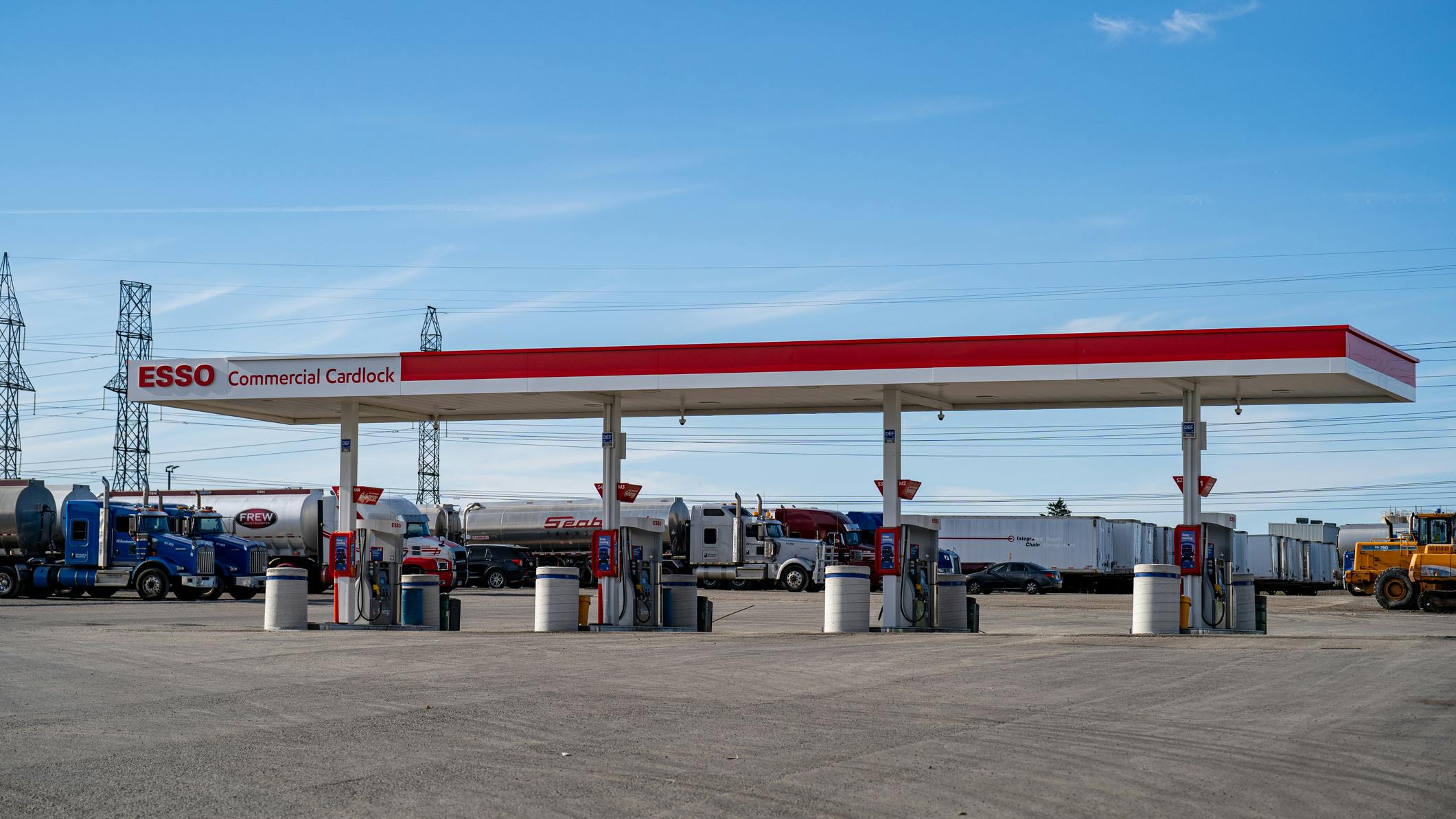 Esso Commercial Cardlock fuel station in Toronto with multiple commercial trucks parked, showcasing fueling infrastructure for fleet operations.