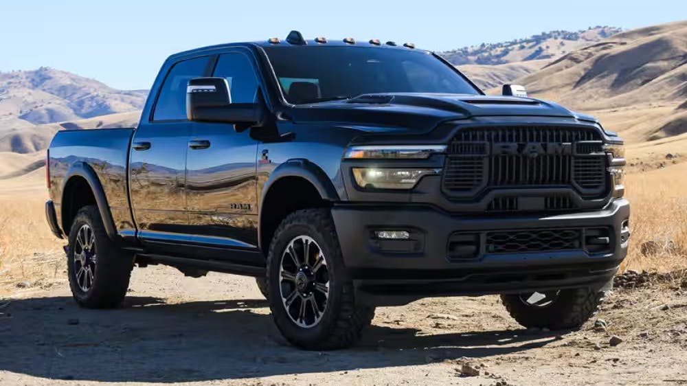 2025 black Ram 2500 pickup truck parked in a desert landscape, showcasing heavy-duty design and off-road capability
