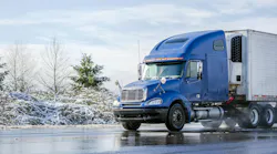 blue tractor with refrigerated trailer in winter blue tractor with refrigerated trailer in winter