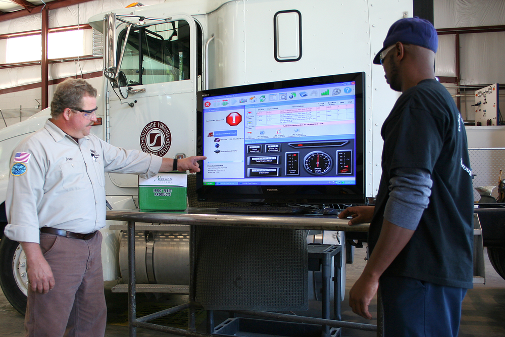 Bryan Lewis, 2007 and 2008 TMCSuperTech Grand Champion and instructor at Southside Virginia Community College, shows a student how to use JPRO Fleet Diagnostics on a heavy duty vehicle.