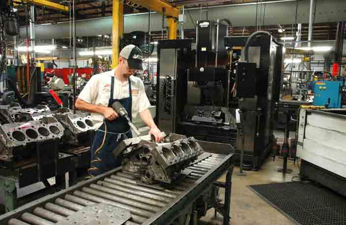Operator installs torque plate on the block before setup in the Sunnen SV-410 machine or CK-21 immediately to the right in photo.