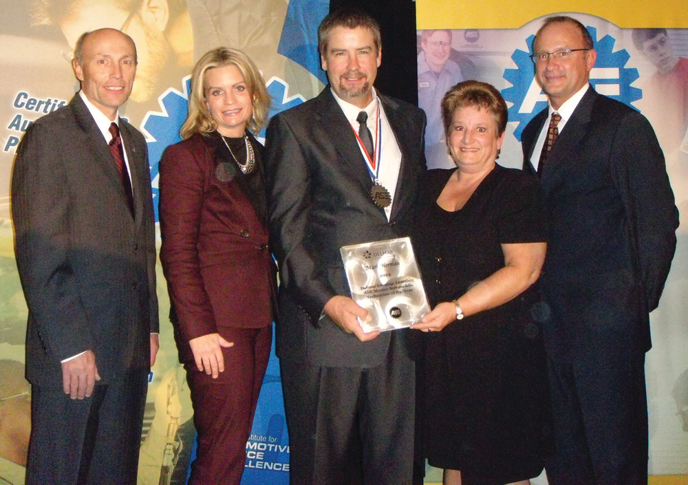 Mark Herman, third from left, accepts his award from Tim Zilke, ASE president and Kristen Davis of Delmar. Second from right is Herman's wife, Janet; at right is Greg Clayton of Delmar.