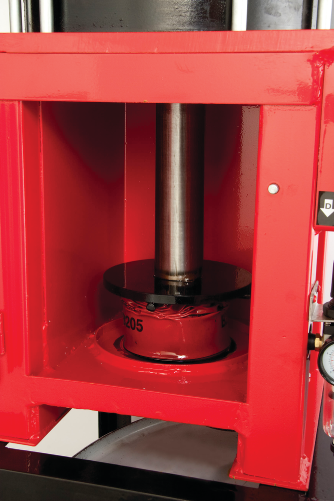 Oil filter crushers are designed specifically to flatten oil filters and to squeeze oil out all but the last traces of engine sludge and oil from inside them. Here, an oil filter can be crushed to 25 percent of its original size.