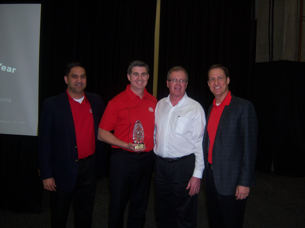 John Castelino, left, Don Guillard, third from left, and Brett Shaw, right, of Mac Tools honor Kirk Clore of Clore Automotive for the best new product of the year.