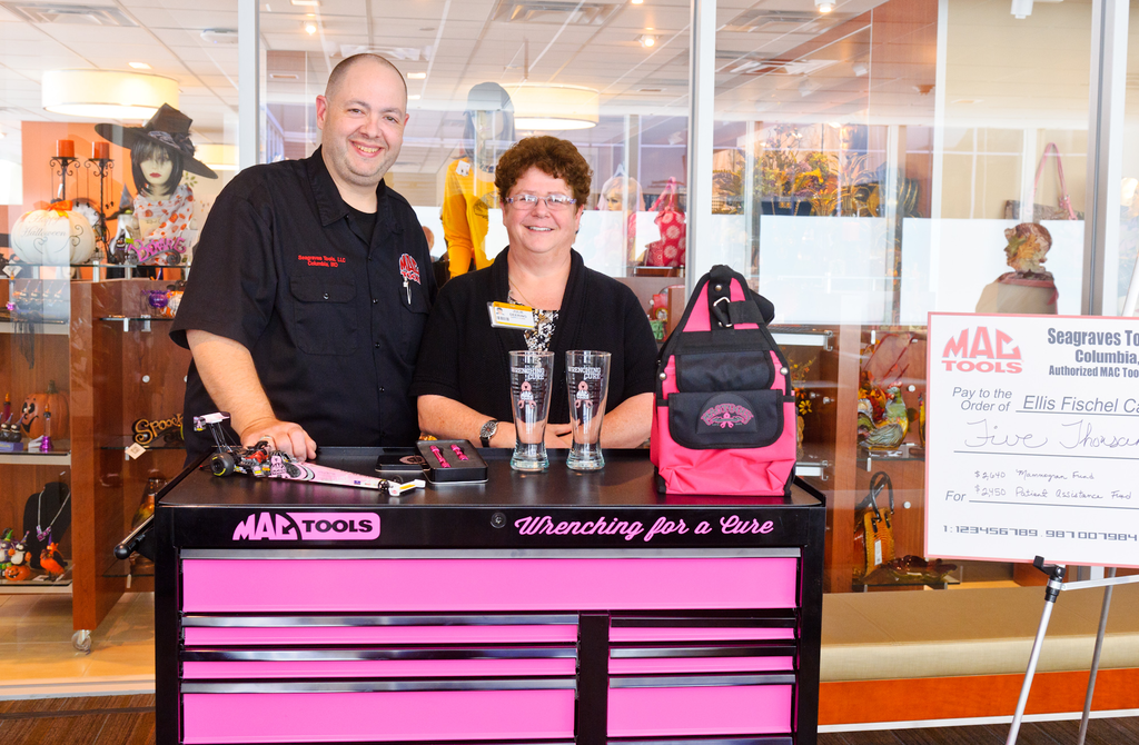 Tom Seagraves congratulates toolbox winner Julie Deering.