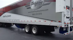 This photo shows three of the four aerodynamic device components that fleets can equip on their trailers. The undertray (blue) at the bottom middle of the trailer, the rear diffuser (blue) at the bottom back of the trailer, and the AeroEdge side fairings (white) at the top back part of the trailer. This photo shows three of the four aerodynamic device components that fleets can equip on their trailers. The undertray (blue) at the bottom middle of the trailer, the rear diffuser (blue) at the bottom back of the trailer, and the AeroEdge side fairings (white) at the top back part of the trailer.